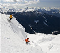 Skiers enjoying Whistler mountain with Black Tusk in the background